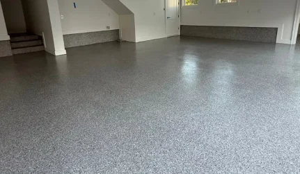 Garage with interior stairs, gray flake floor that also covers the low stem wall ledge along the walls in Shenandoah, LA
